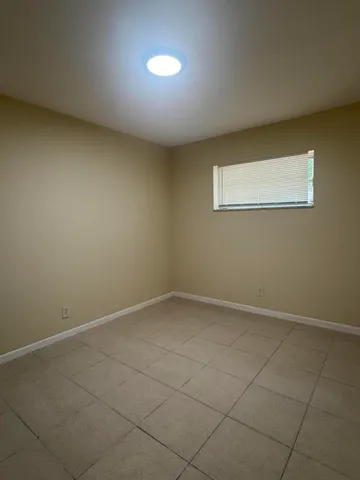 an empty room with a empty space and window