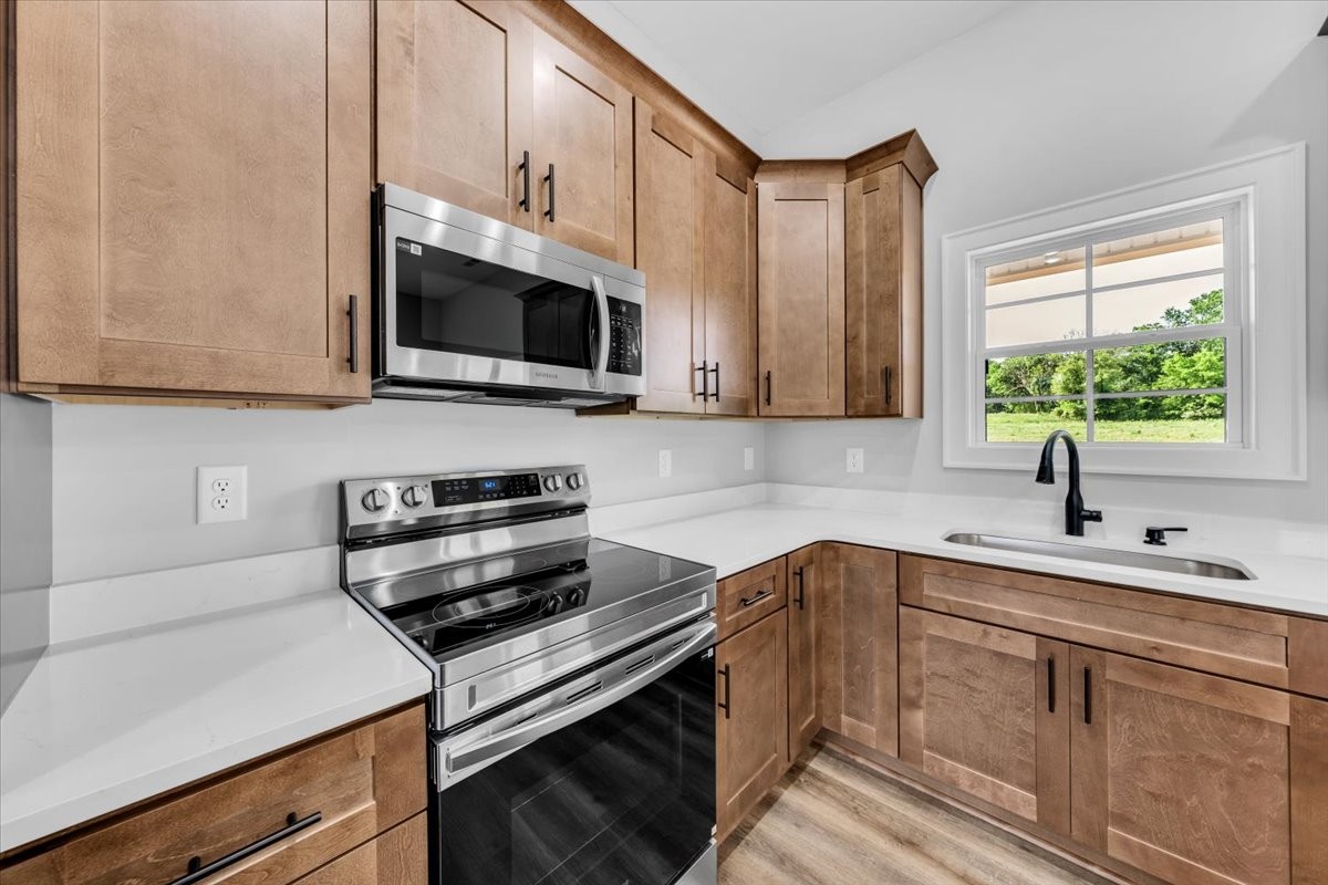 749 Edd Ramsey Road McMinnville, TN 37110 - Photo 14 of 40 a kitchen with stainless steel appliances a stove sink microwave and cabinets