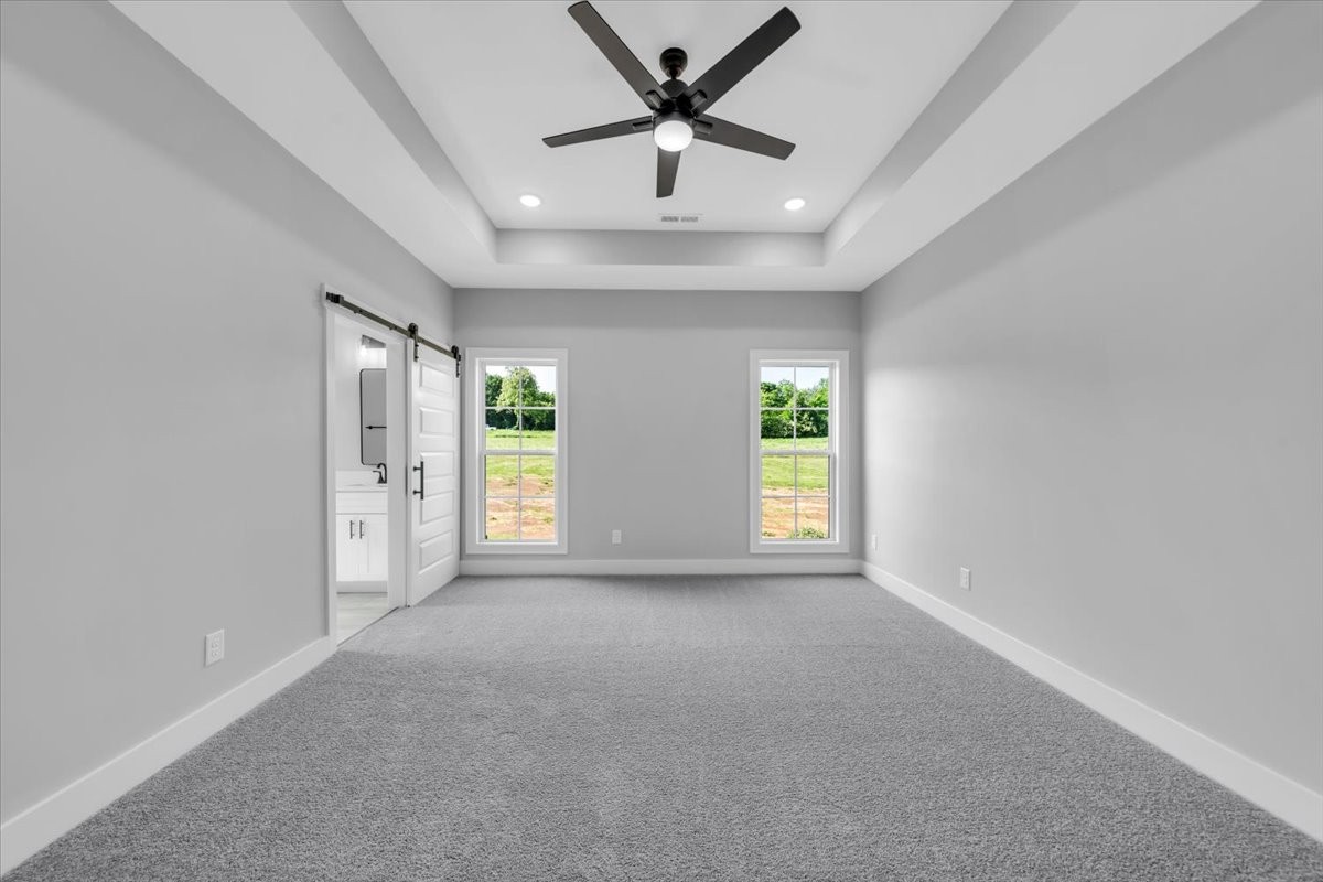749 Edd Ramsey Road McMinnville, TN 37110 - Photo 26 of 40 an empty room with windows and a ceiling fan