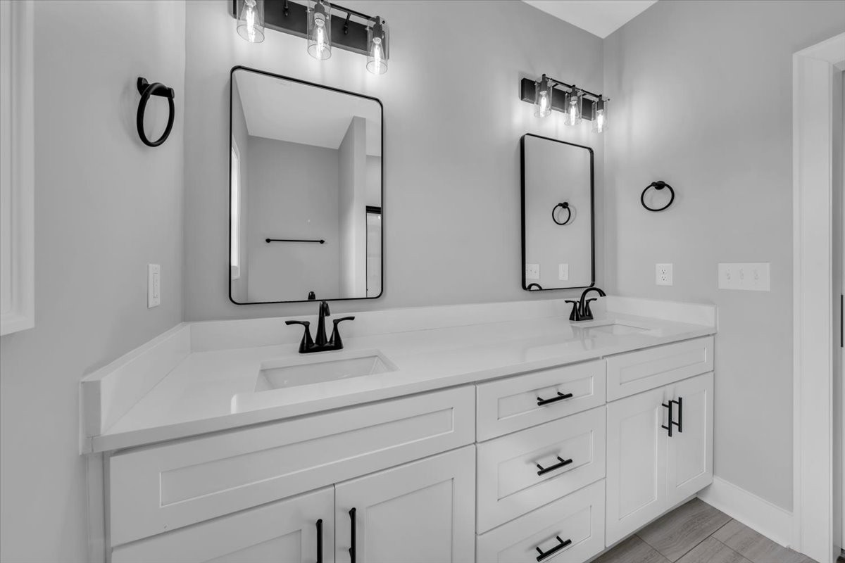 749 Edd Ramsey Road McMinnville, TN 37110 - Photo 33 of 40 a bathroom with a double vanity sink and a mirror
