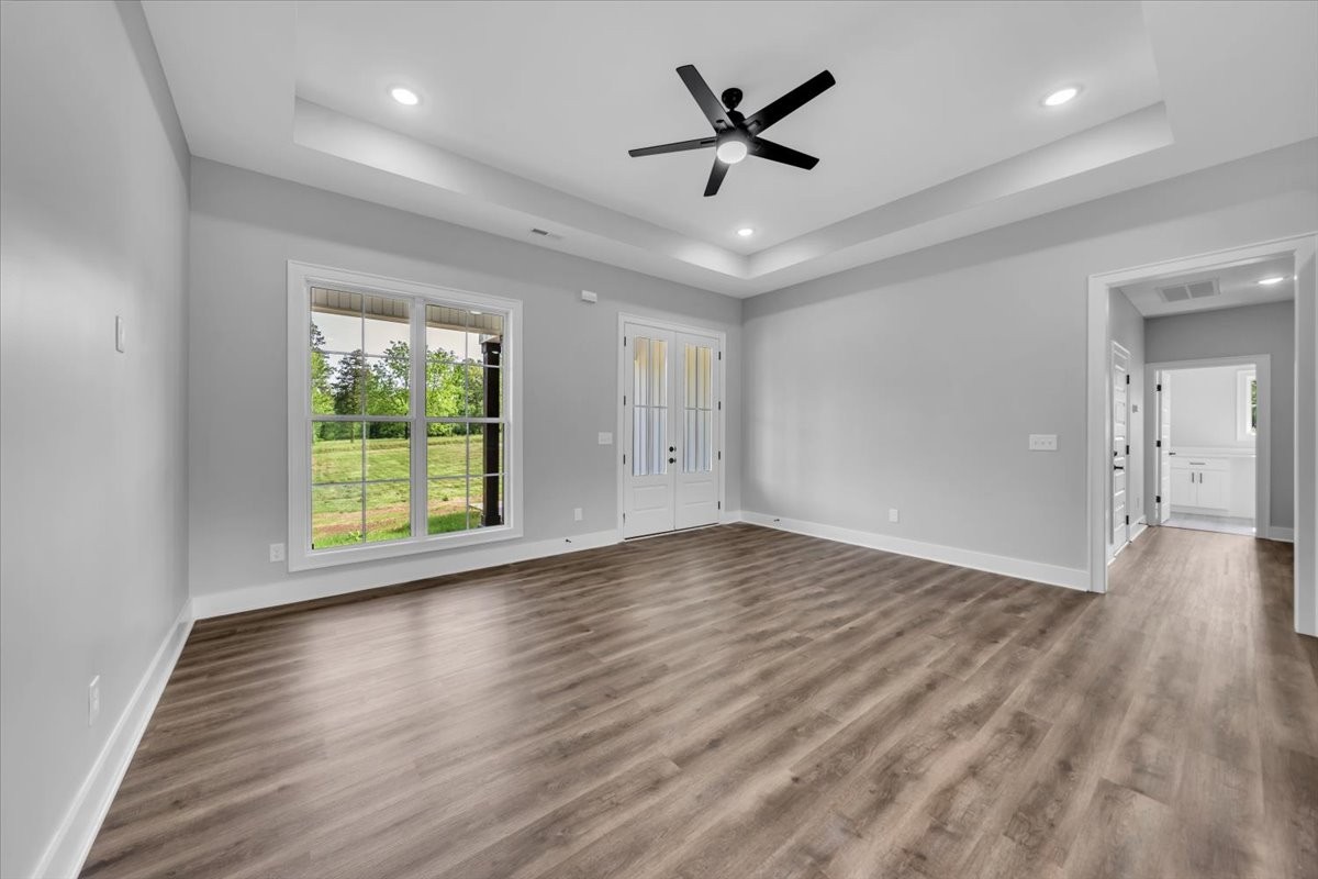 749 Edd Ramsey Road McMinnville, TN 37110 - Photo 8 of 40 an empty room with wooden floor and windows