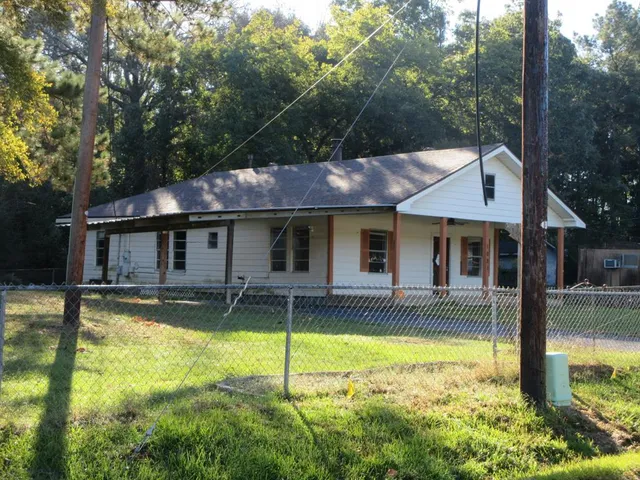 a view of a house with swimming pool and sitting area