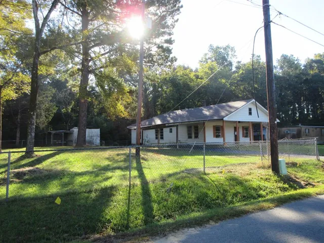 a view of a swimming pool with a patio and a yard