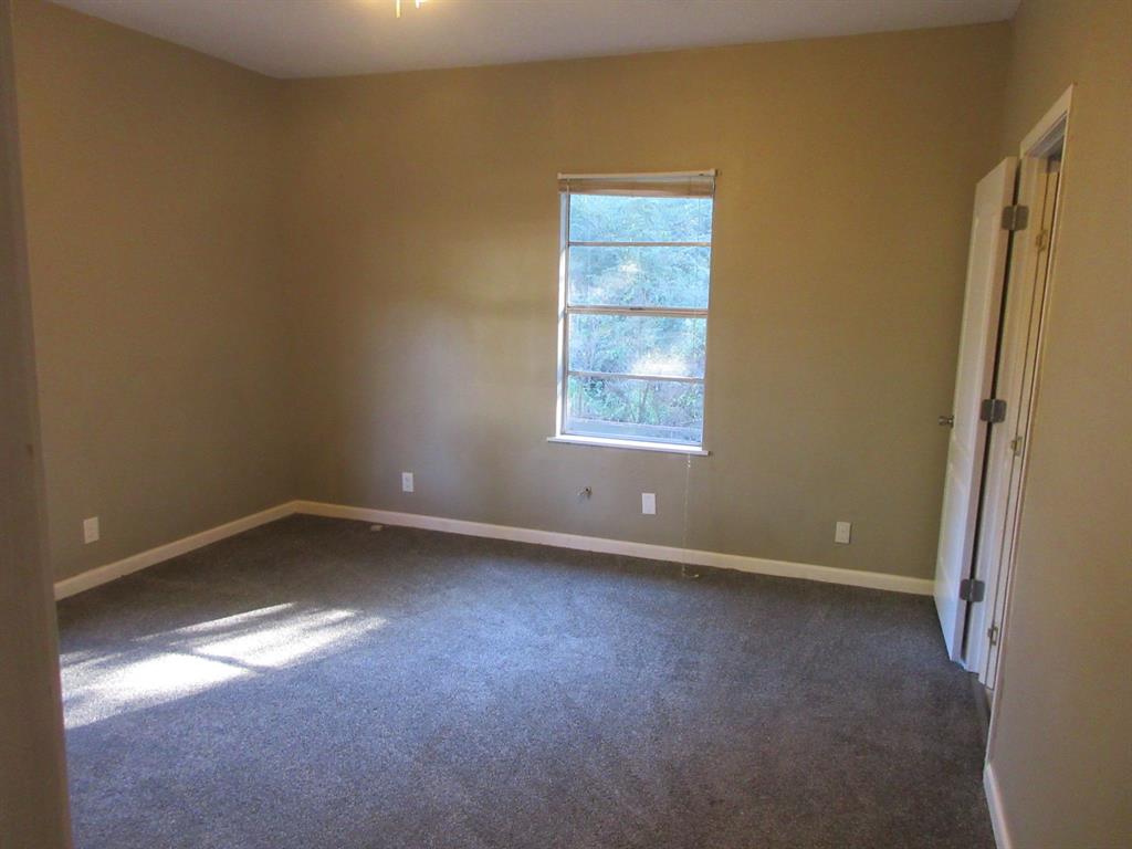 1021 Scarpengo Road Shreveport, LA 71107 - Photo 9 of 22 an empty room with a window