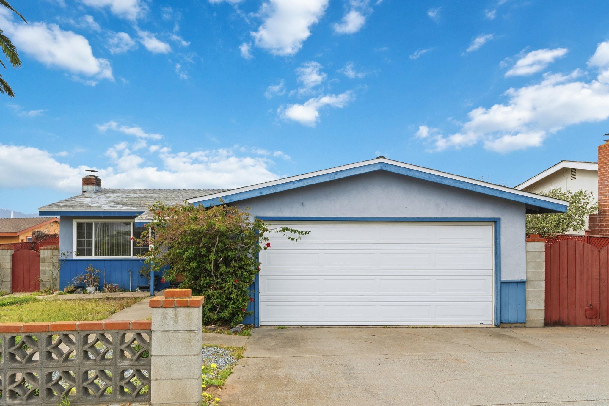 1609 Darwin Street Seaside, CA 93955 - Photo 1 of 26 View of front of house featuring a garage, a chimney, driveway, and a gate
