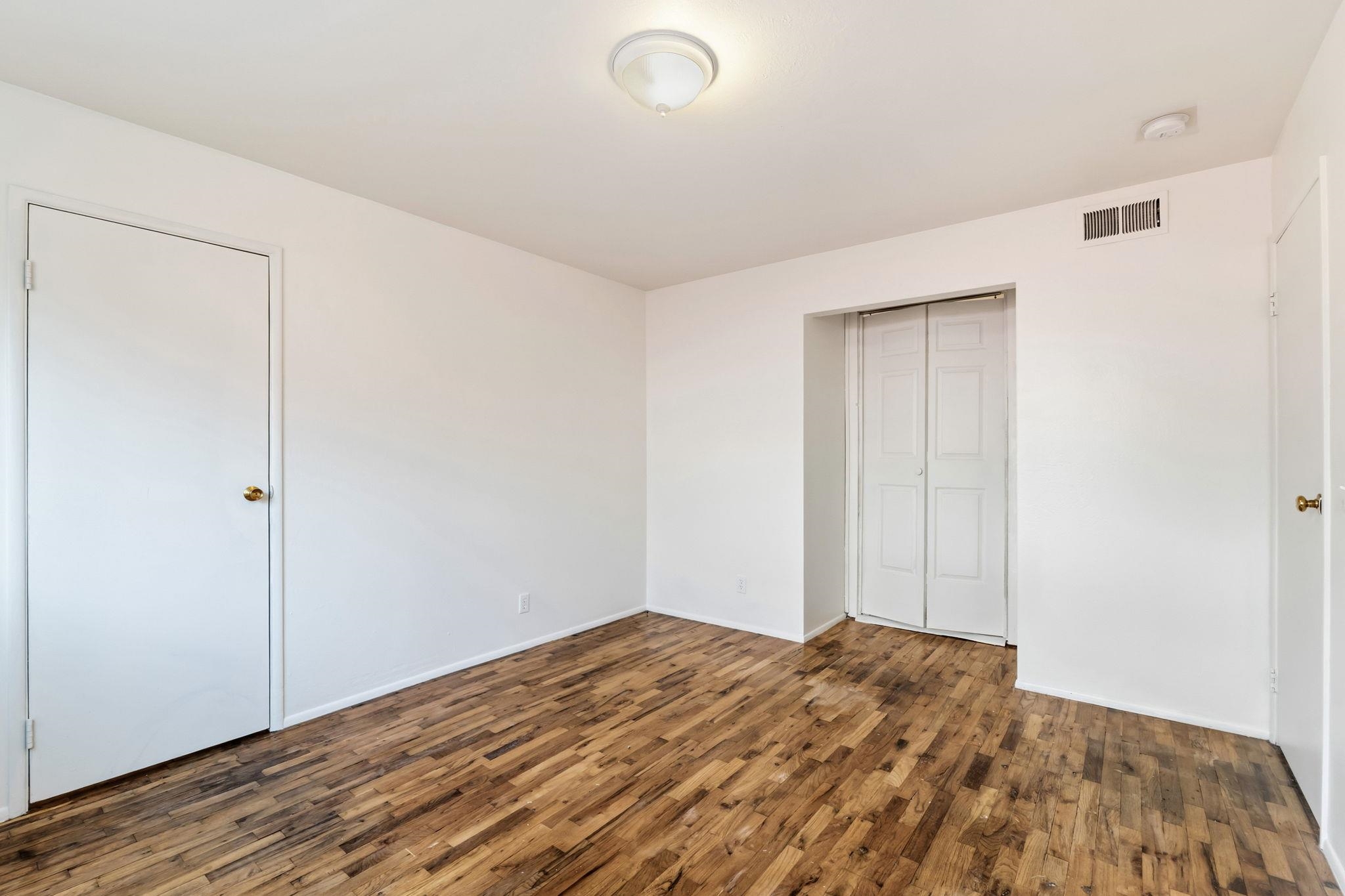 1609 Darwin Street Seaside, CA 93955 - Photo 17 of 26 Unfurnished bedroom featuring dark wood-style flooring and a closet