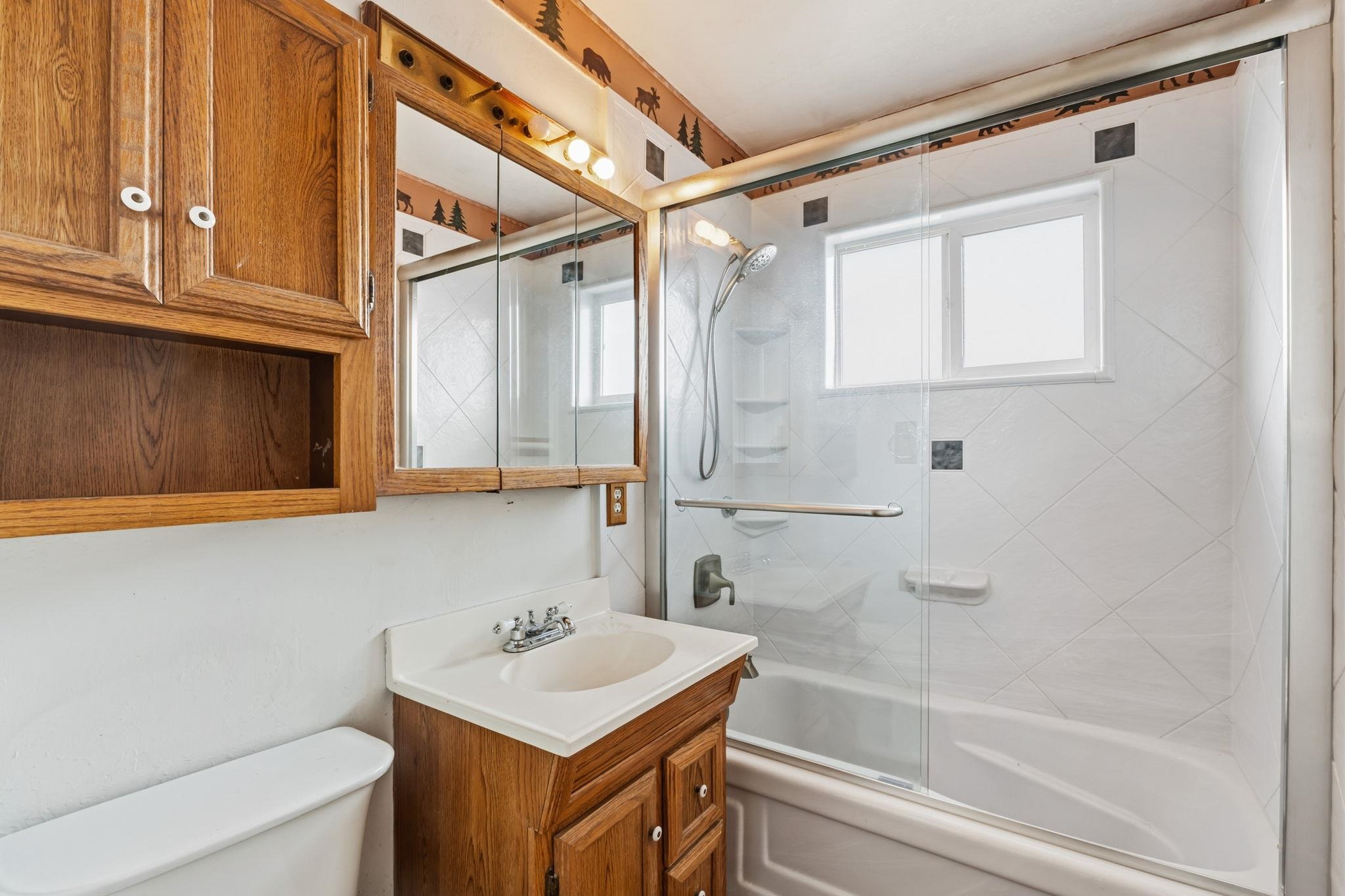 1609 Darwin Street Seaside, CA 93955 - Photo 19 of 26 Full bath with vanity, combined bath / shower with glass door, and plenty of natural light off the hallway.