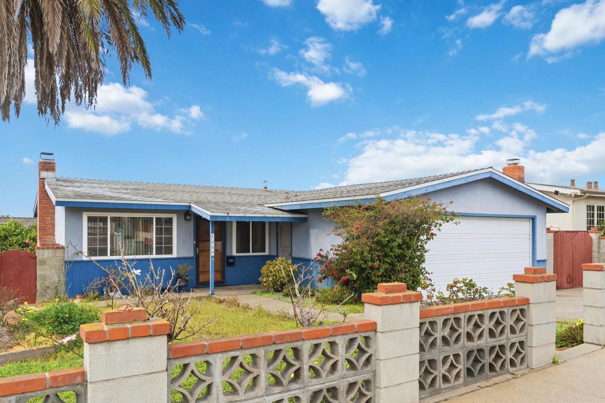 1609 Darwin Street Seaside, CA 93955 - Photo 2 of 26 Ranch-style house with a fenced front yard, stucco siding, a garage, a chimney, and a gate
