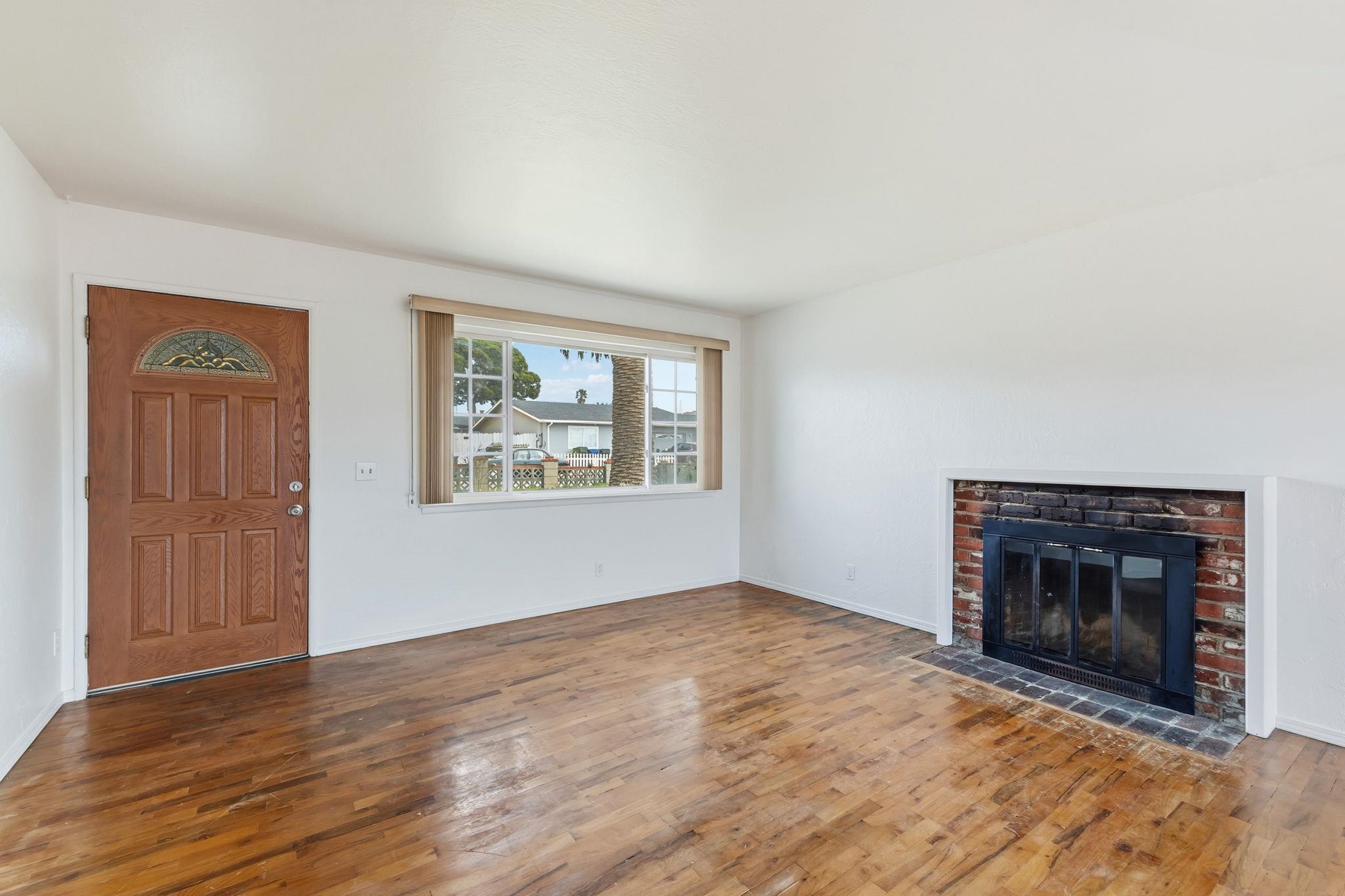 1609 Darwin Street Seaside, CA 93955 - Photo 7 of 26 Unfurnished living room with wood-type flooring and a brick fireplace