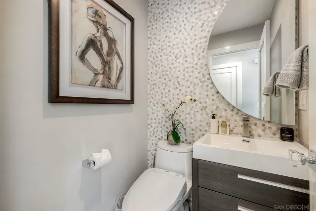 a bathroom with a toilet a sink and a mirror