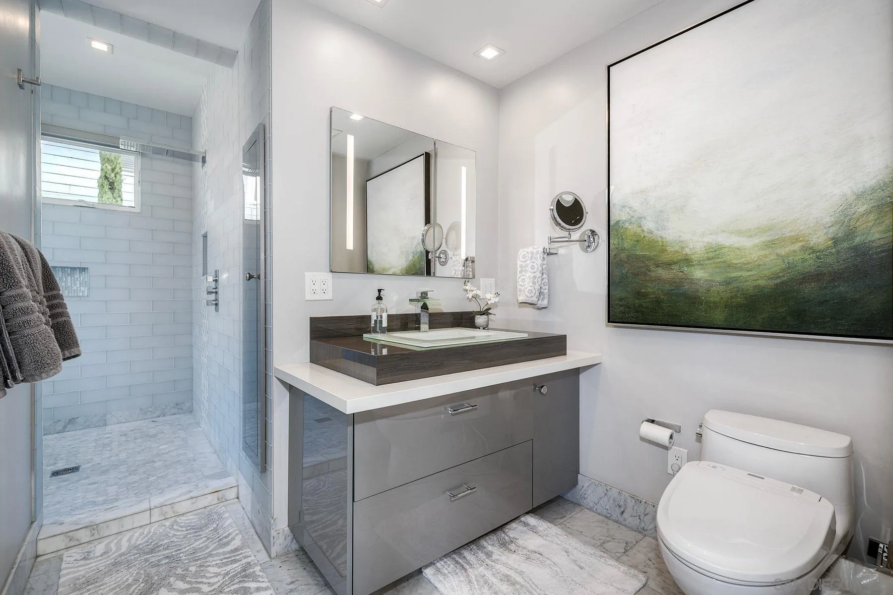 911 9th Street Coronado, CA 92118 - Photo 16 of 35 a bathroom with a sink a toilet and shower