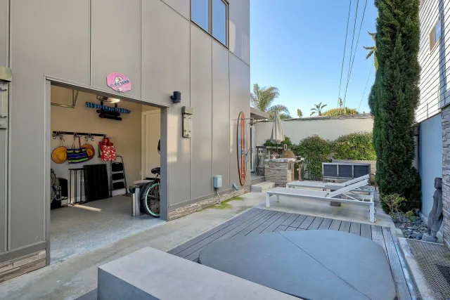 a view of a house with backyard porch and sitting area