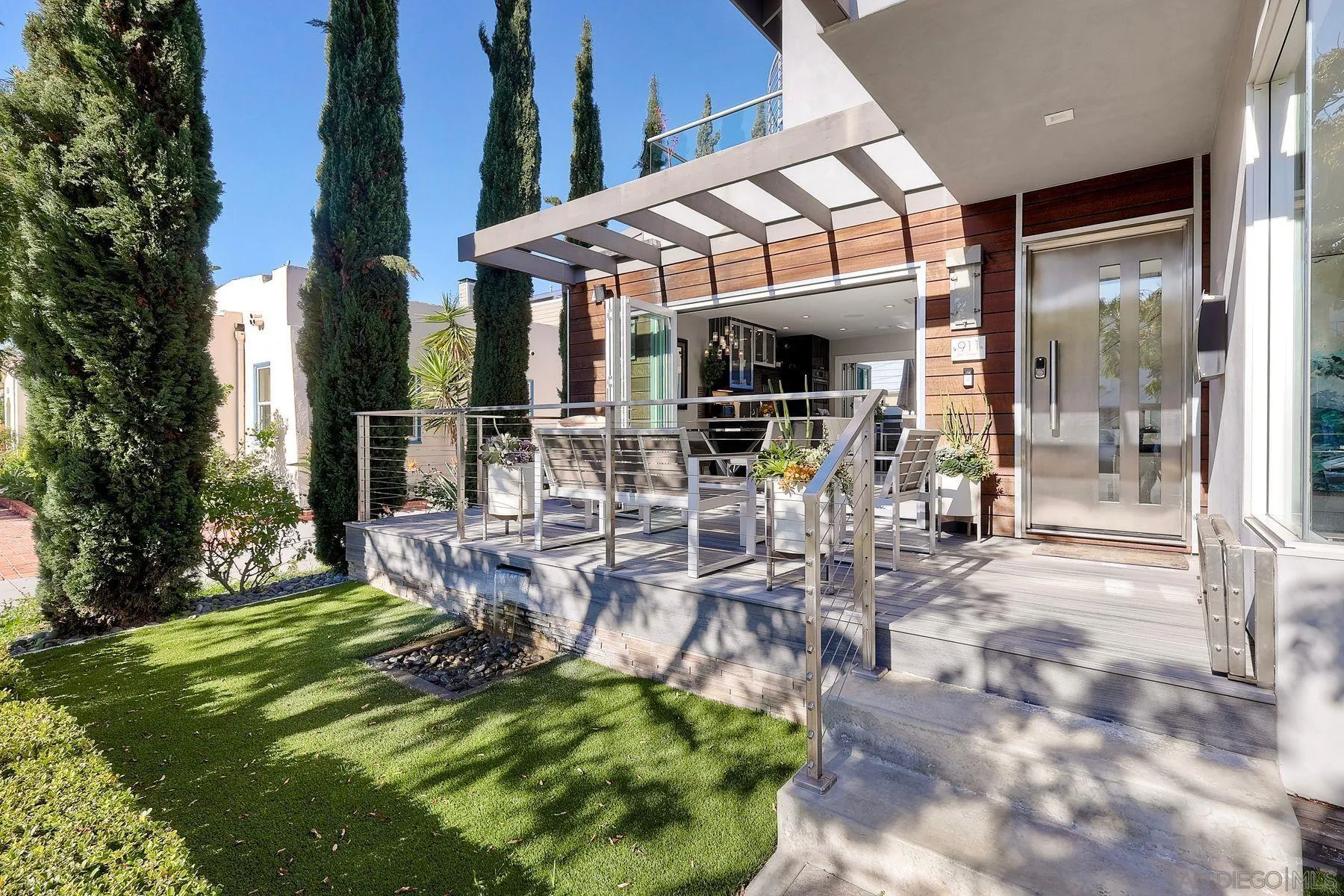 911 9th Street Coronado, CA 92118 - Photo 30 of 35 a view of a patio with table and chairs with wooden floor and fence