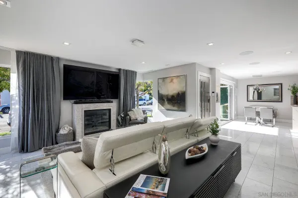 a living room with furniture a flat screen tv and a fireplace