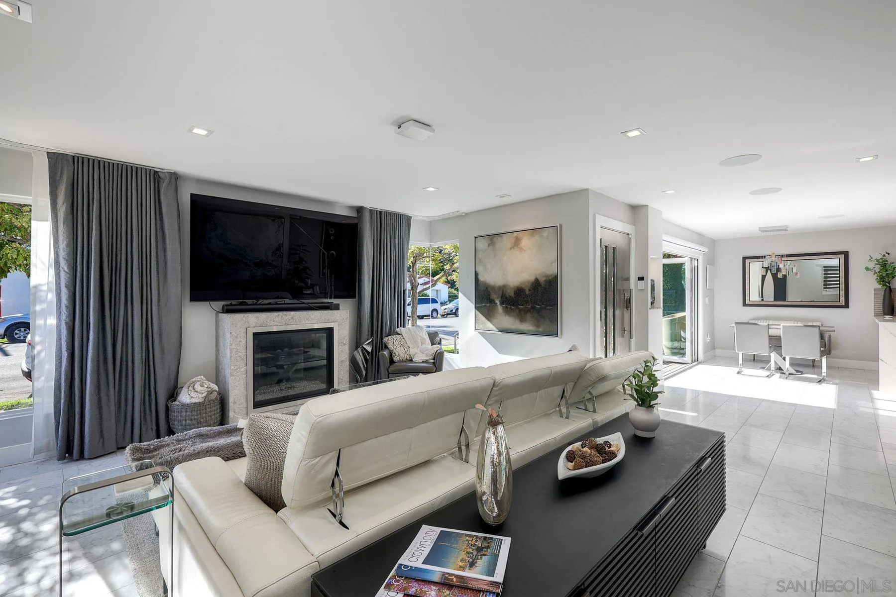 911 9th Street Coronado, CA 92118 - Photo 3 of 35 a living room with furniture a flat screen tv and a fireplace