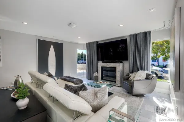 a living room with fireplace furniture and a flat screen tv