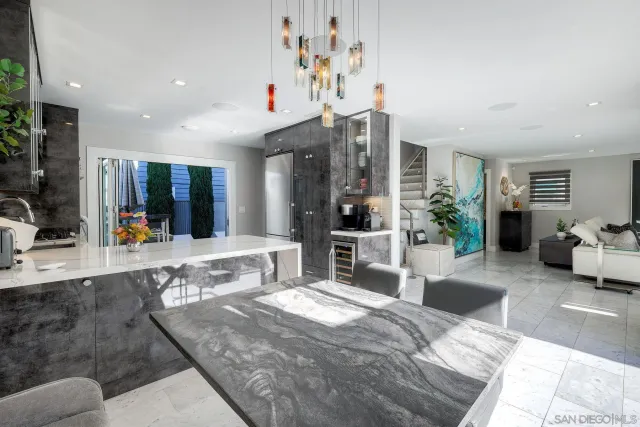 a bedroom with a large bed a potted plant and a large window