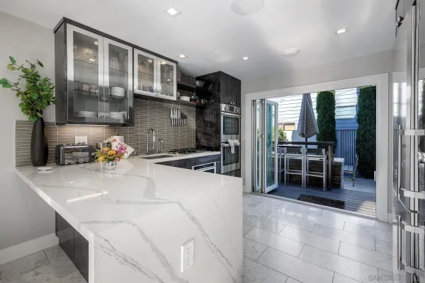 a kitchen with stainless steel appliances a sink and a refrigerator