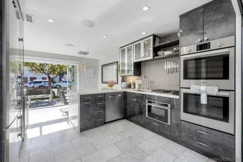 a large kitchen with stainless steel appliances granite countertop a stove and a sink