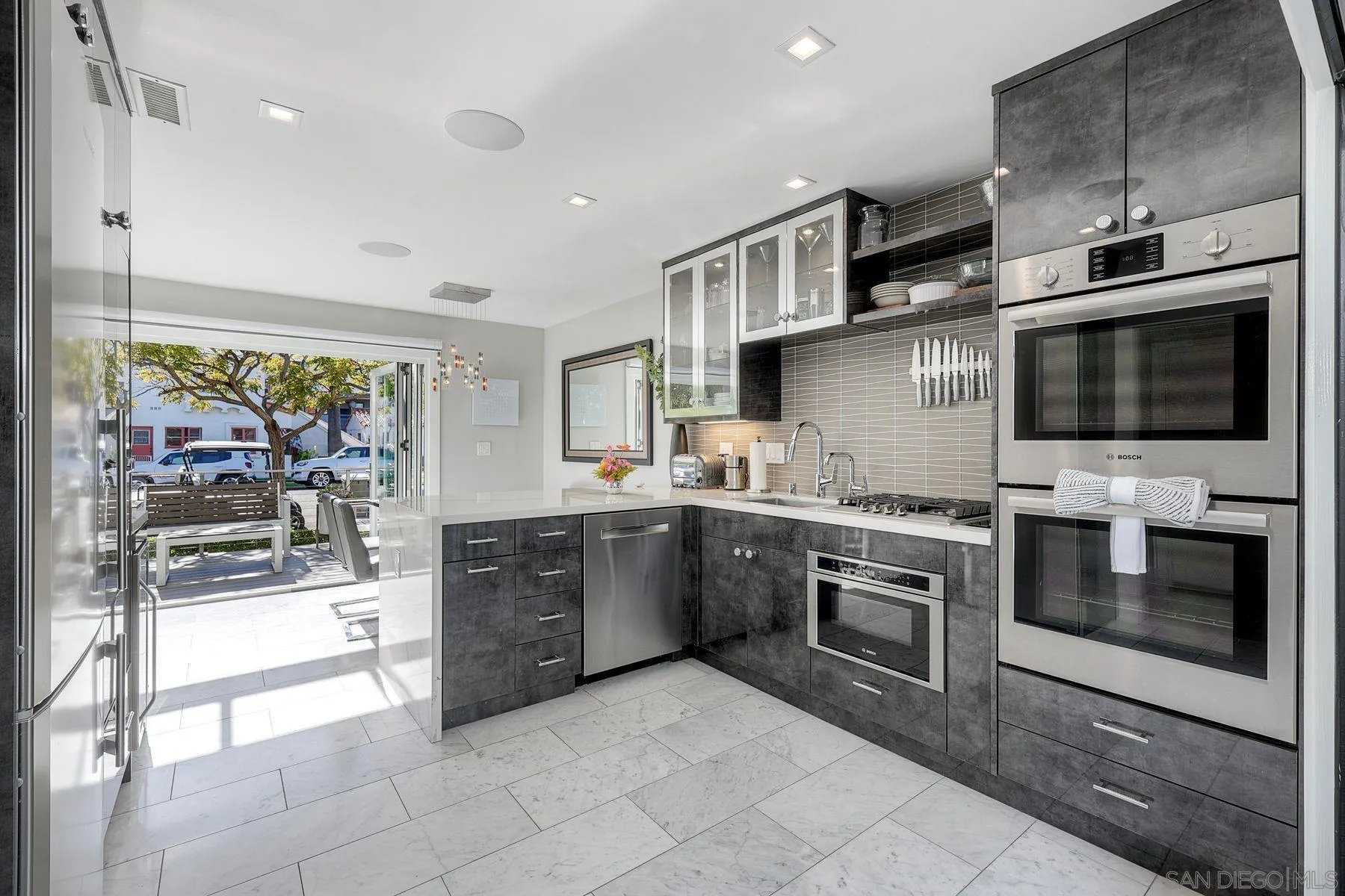 911 9th Street Coronado, CA 92118 - Photo 9 of 35 a large kitchen with stainless steel appliances granite countertop a stove and a sink