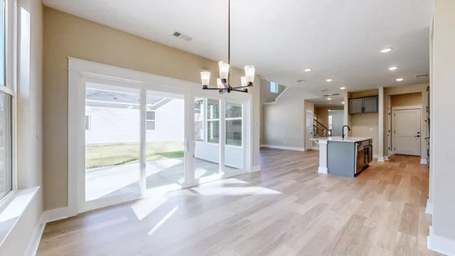 a view of a living room and kitchen with windows