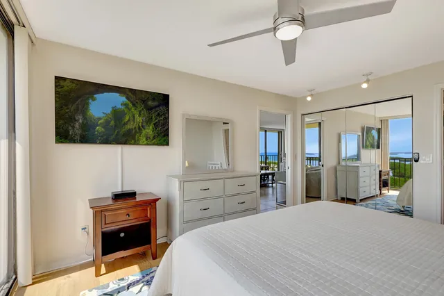 a bathroom with a granite countertop double vanity sink a mirror and shower