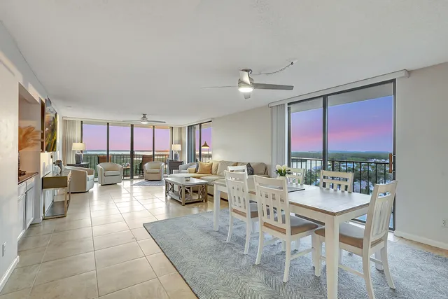 a living room with patio furniture and a large window