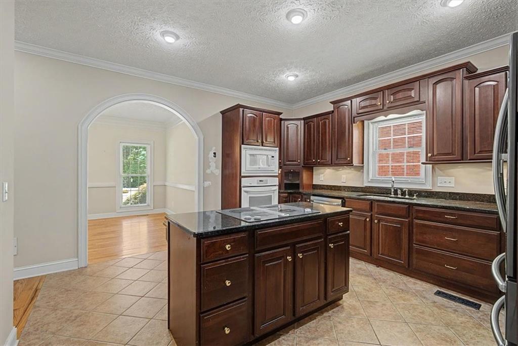 1136 Cole Lake Road Dallas, GA 30157 - Photo 25 of 72 a kitchen with stainless steel appliances granite countertop a stove sink and cabinets