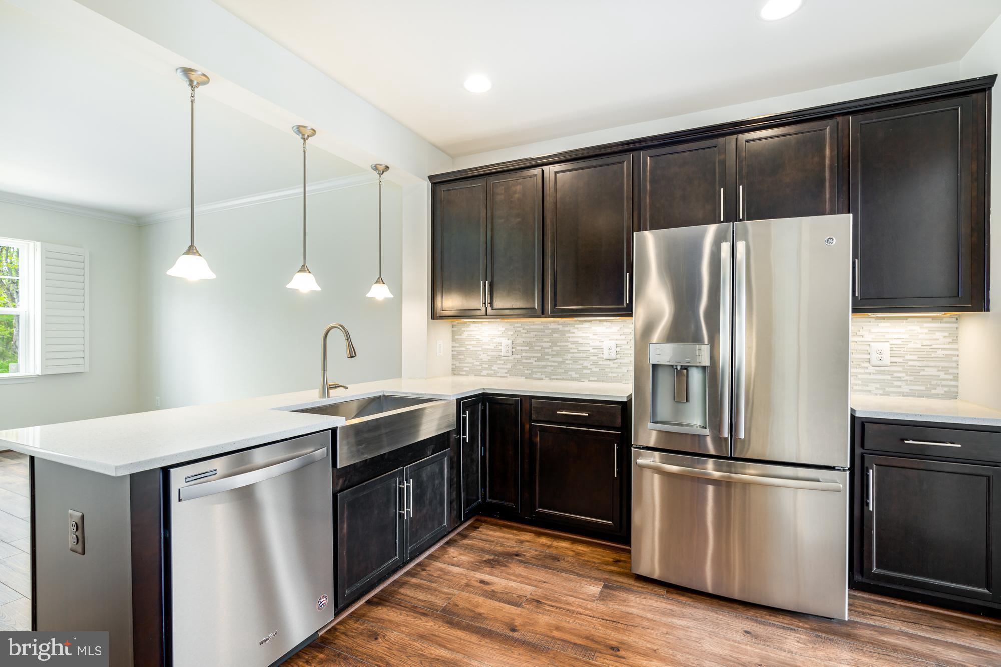 112 Prickly Pear Place Stephenson, VA 22656 - Photo 13 of 31 a kitchen with kitchen island granite countertop a sink appliances and cabinets
