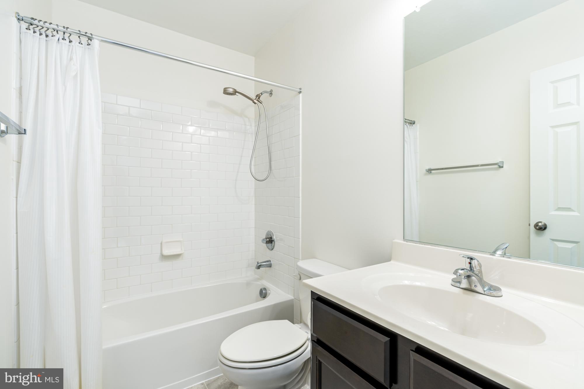 112 Prickly Pear Place Stephenson, VA 22656 - Photo 29 of 31 a bathroom with a sink a toilet and shower
