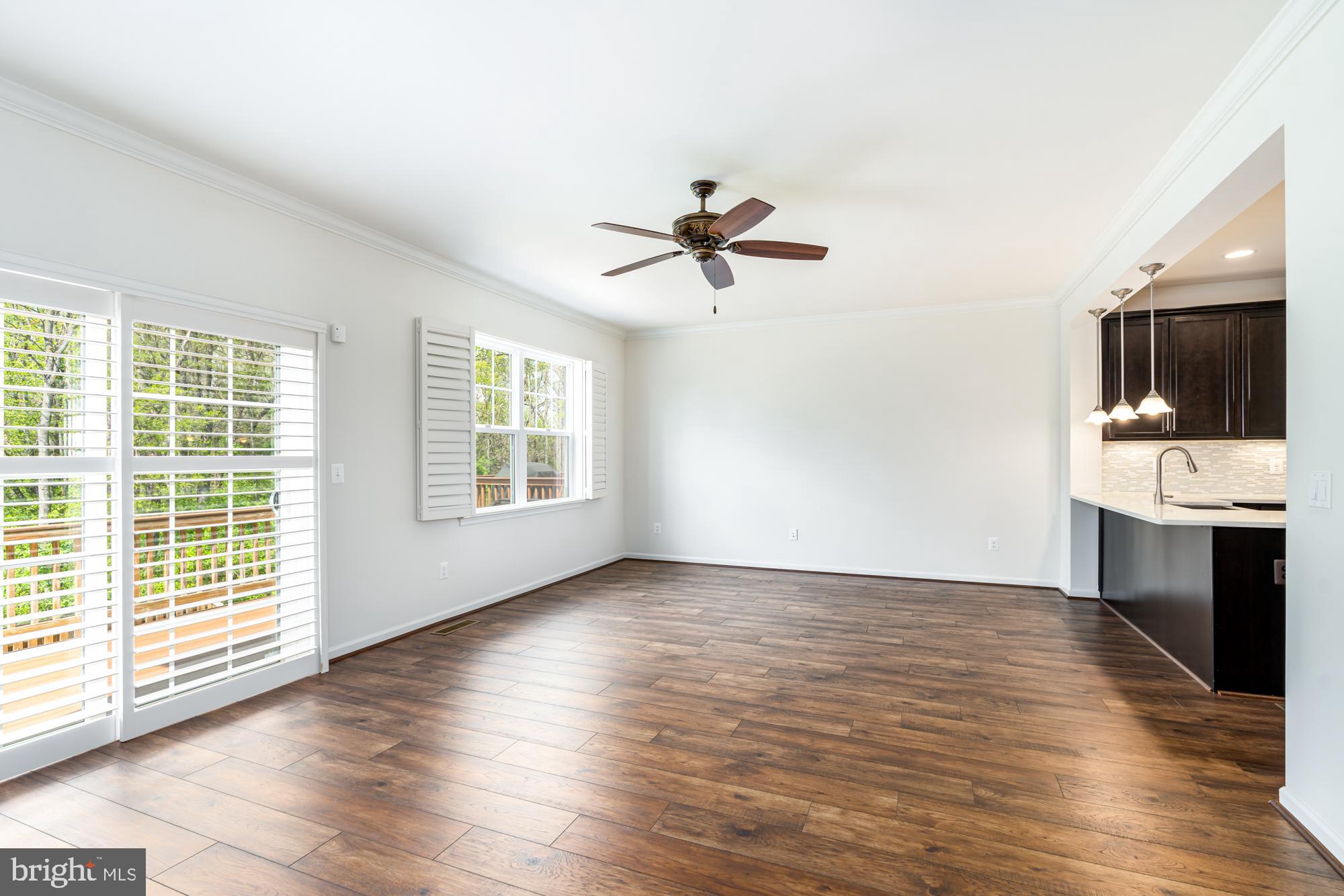 112 Prickly Pear Place Stephenson, VA 22656 - Photo 7 of 31 a view of an empty room with a kitchen and wooden floor