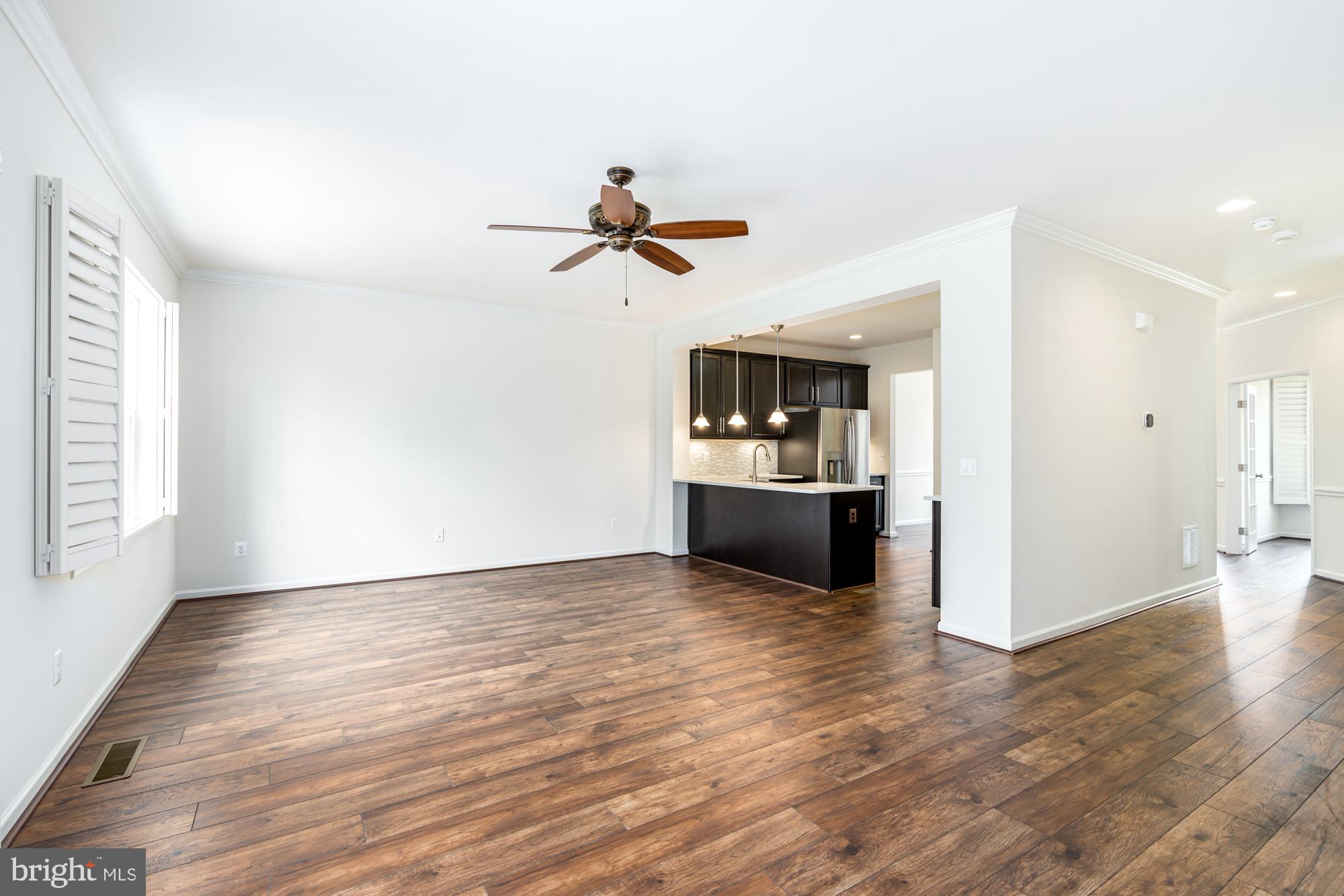 112 Prickly Pear Place Stephenson, VA 22656 - Photo 8 of 31 a view of a kitchen with wooden floor and a ceiling fan