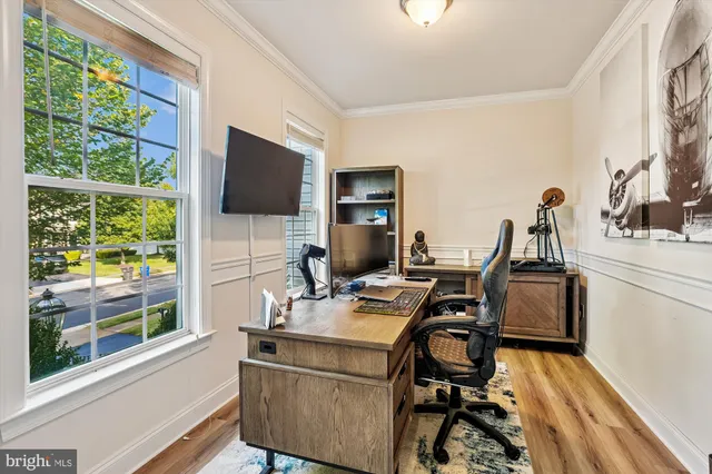 a view of a workspace with furniture and a window