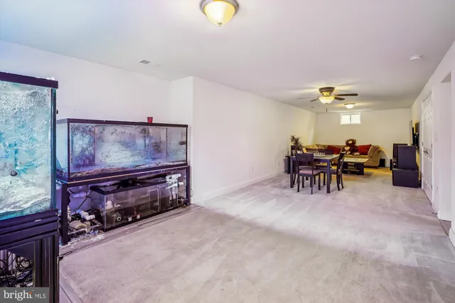 a living room with furniture and dining area