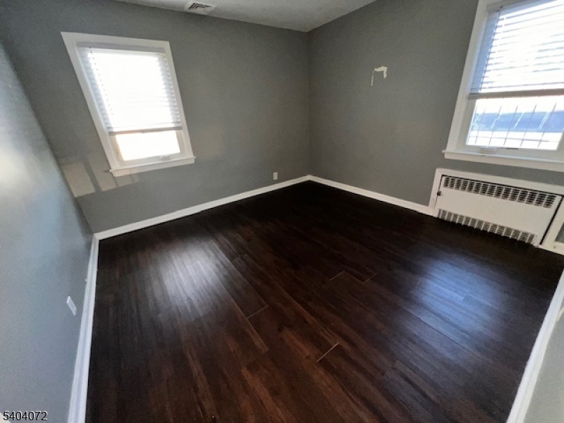 10 Federal Street, Unit 2 Belleville, NJ 07109 - Photo 7 of 10 an empty room with wooden floor and windows