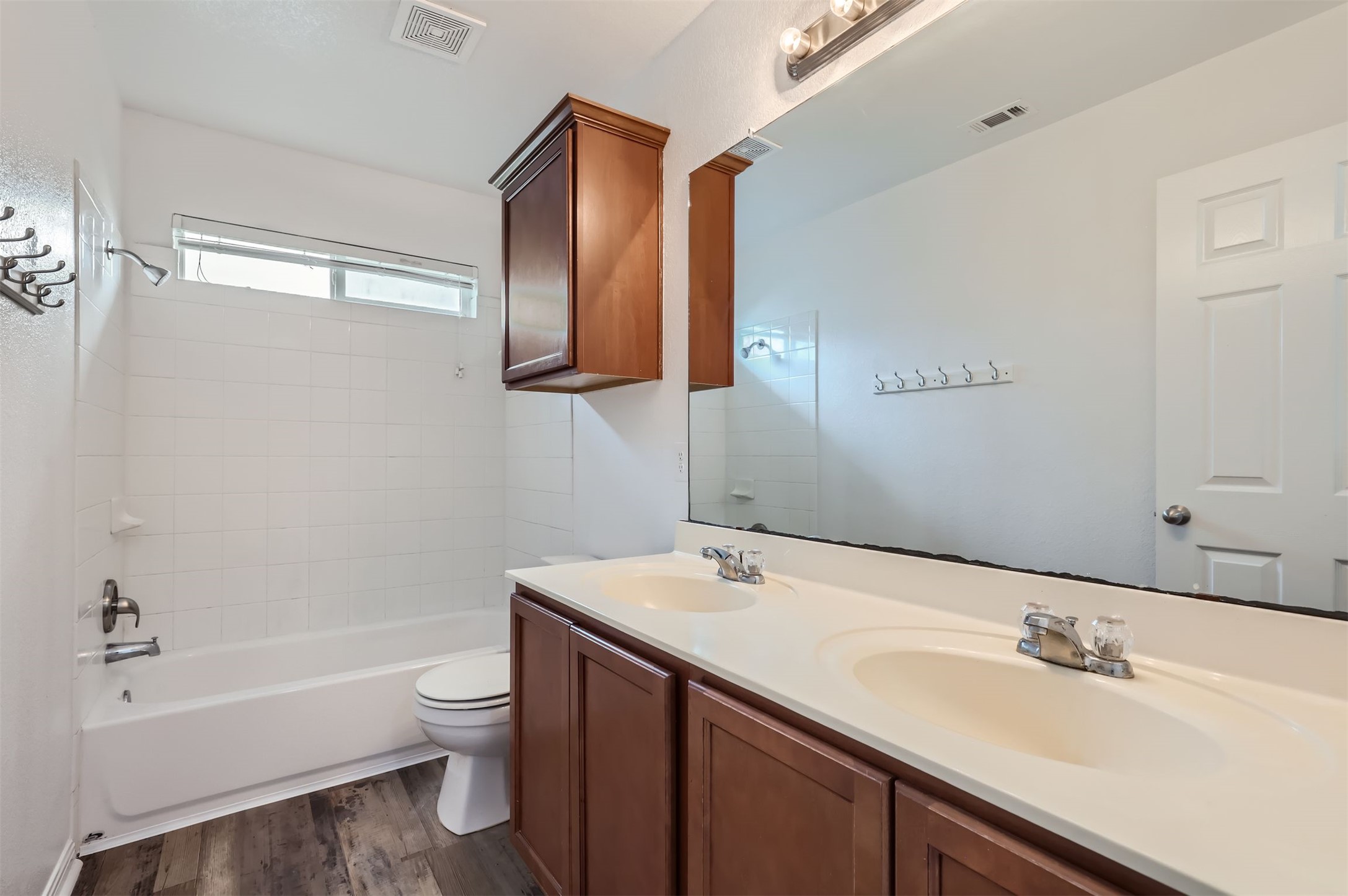 131 Lavaca Loop Hutto, TX 78634 - Photo 21 of 29 Double vanity sinks and a combined tub and shower make this bathroom highly functional.