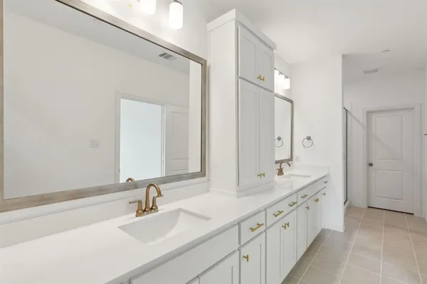 a bathroom with a double vanity sink mirror and double