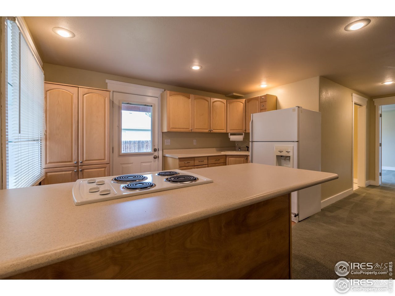 1278 Trail Ridge Road Longmont, CO 80504 - Photo 23 of 38 a kitchen with kitchen island a sink table and chairs