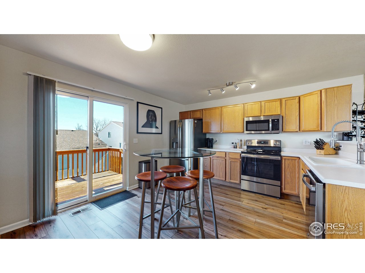 1278 Trail Ridge Road Longmont, CO 80504 - Photo 5 of 38 a kitchen with a table chairs refrigerator and microwave