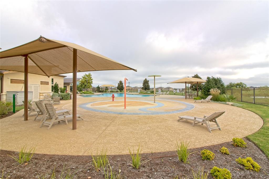 1012 Paddock Lane Georgetown, TX 78626 - Photo 14 of 15 A community pool area, complete with shaded lounging spots and a children's splash pad, invites endless summer enjoyment.