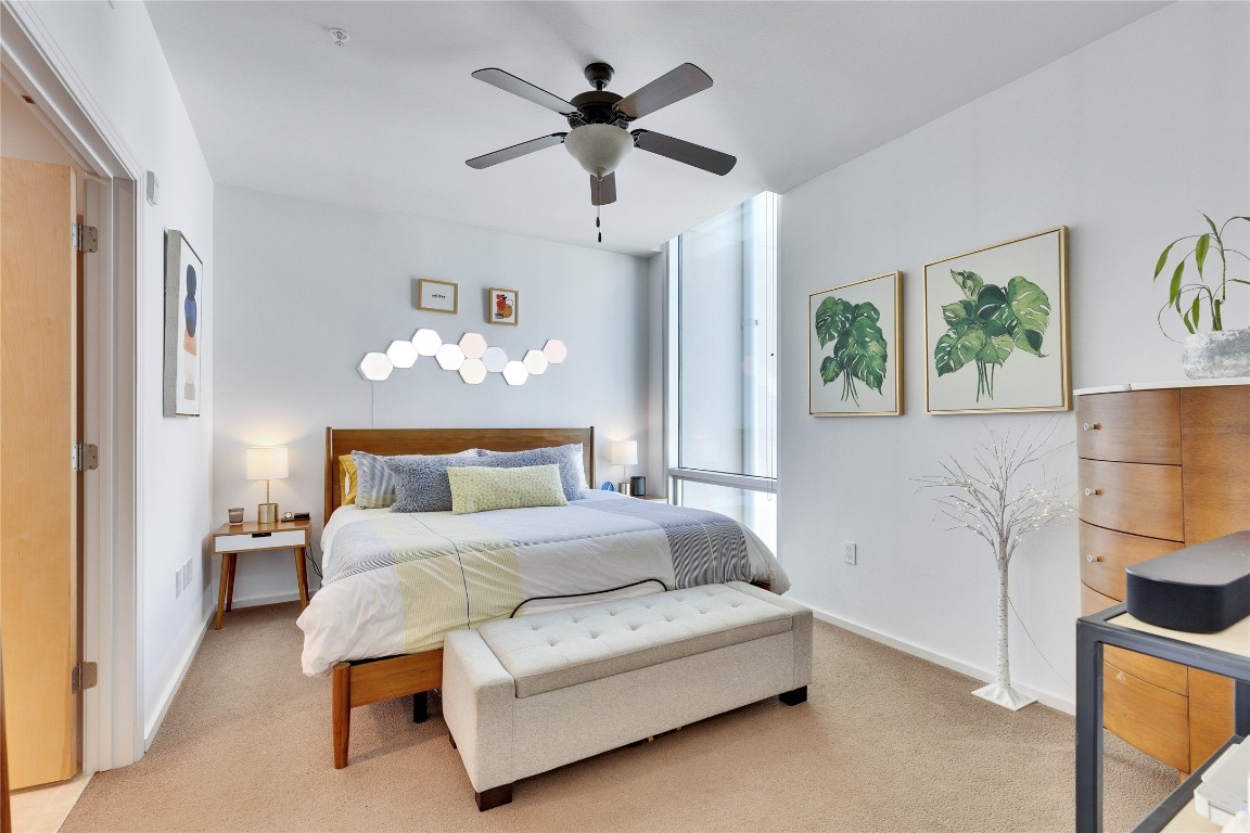 1600 Barton Springs Road, Unit 2403 Austin, TX 78704 - Photo 17 of 40 a spacious bedroom with a bed and a painting on the wall