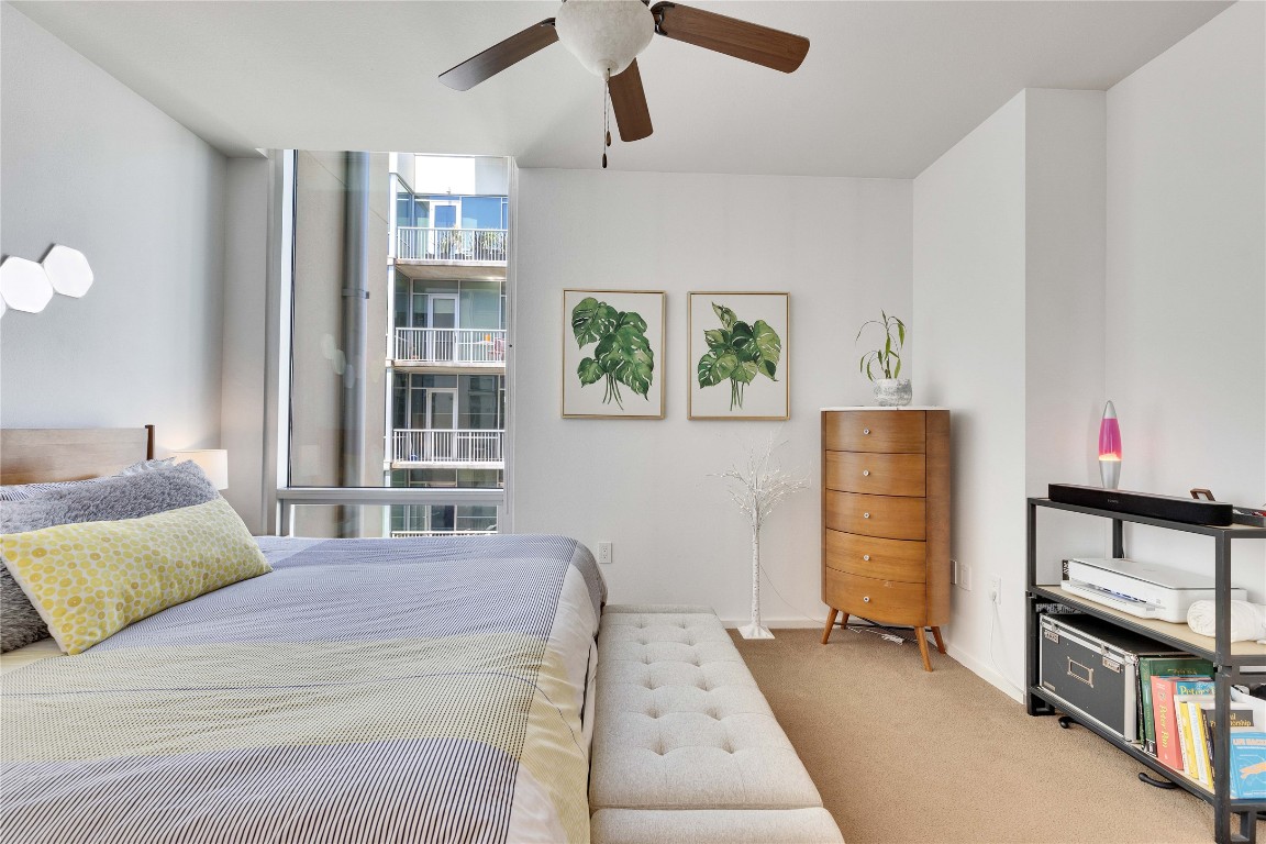 1600 Barton Springs Road, Unit 2403 Austin, TX 78704 - Photo 18 of 40 a bedroom with a bed dresser and a window