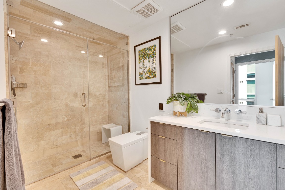 1600 Barton Springs Road, Unit 2403 Austin, TX 78704 - Photo 28 of 40 a bathroom with a sink a toilet and shower