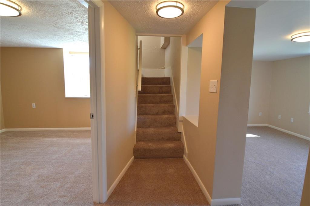 236 Hockey Road Tarrs, PA 15688 - Photo 20 of 25 Coming down the stairs from the foyer/entry room. Bedroom to the left and game room to the right.