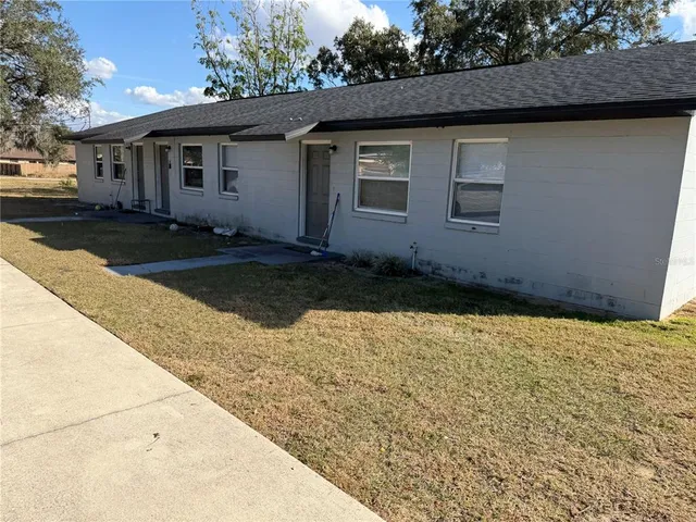 a kitchen with a refrigerator and a stove top oven