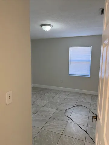 a view of a room with a sink and cabinets