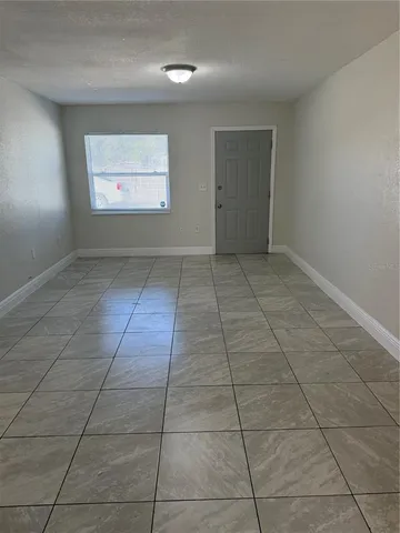 an empty room with white walls and tiles
