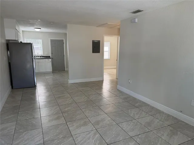 a view of kitchen with furniture and refrigerator