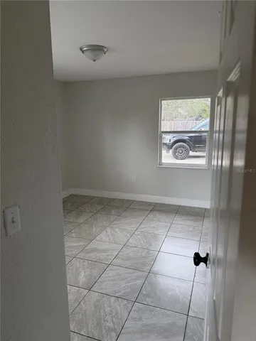 a view of an empty room with a window