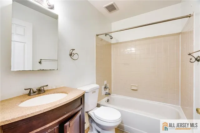 a kitchen with stainless steel appliances granite countertop a refrigerator a stove a sink and a microwave